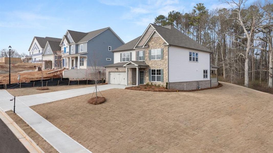 Front exterior of a new home in Holland Estates, Powder Springs, GA, highlighting curb appeal (Image 28). Front exterior of a new home in Holland Estates, Powder Springs, GA, highlighting curb appeal (Image 28).