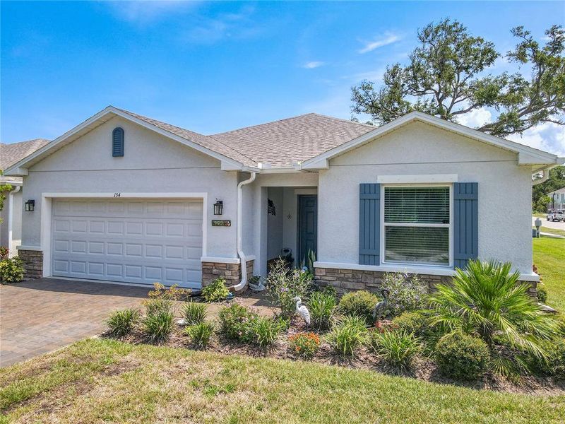 Front exterior of a new home in Riverfront, Edgewater, FL, highlighting curb appeal (Image 25).