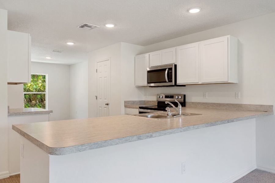 Representative furnished interior of a home built from the Foxtail by Holiday Builders in Port St Lucie, Port St. Lucie (Image 6).