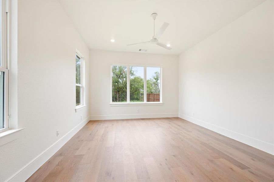 Empty room featuring light hardwood / wood-style floors and ceiling fan