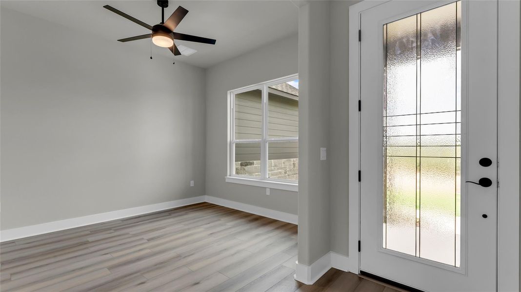 Entryway with a ceiling fan and wood finished floors