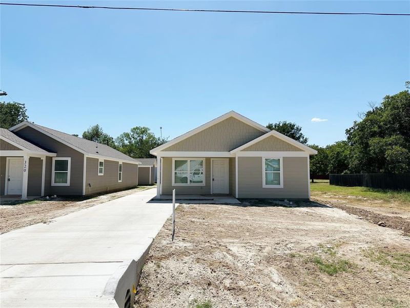 Front exterior of a new home in , Mineral Wells, TX, highlighting curb appeal (Image 1). Front exterior of a new home in , Mineral Wells, TX, highlighting curb appeal (Image 1).