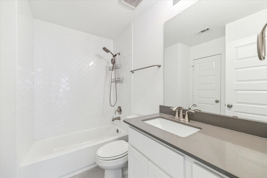 The other full bathroom upstairs is also very neutral with the gray countertop and white cabinets. The other full bathroom upstairs is also very neutral with the gray countertop and white cabinets.