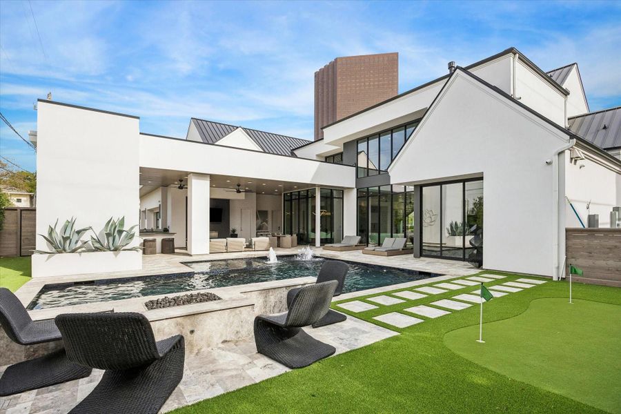 The backyard has turf, generator, putting green, a fireplace, and a fire pit with seating. The backyard has turf, generator, putting green, a fireplace, and a fire pit with seating.