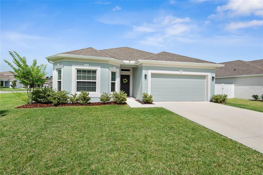 Front exterior of a new home in Sawmill Creek at Palm Coast Park, Palm Coast, FL, highlighting curb appeal (Image 1). Front exterior of a new home in Sawmill Creek at Palm Coast Park, Palm Coast, FL, highlighting curb appeal (Image 1).