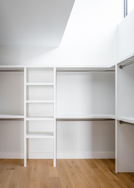 Spacious closet with light wood-style flooring