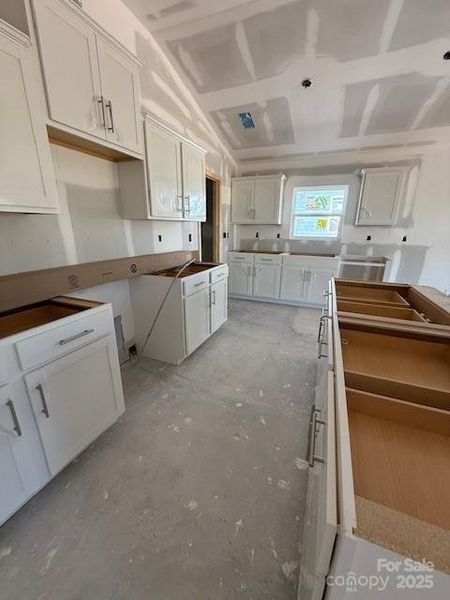 Spacious kitchen with gas range, kitchen island, walk in pantry and more!