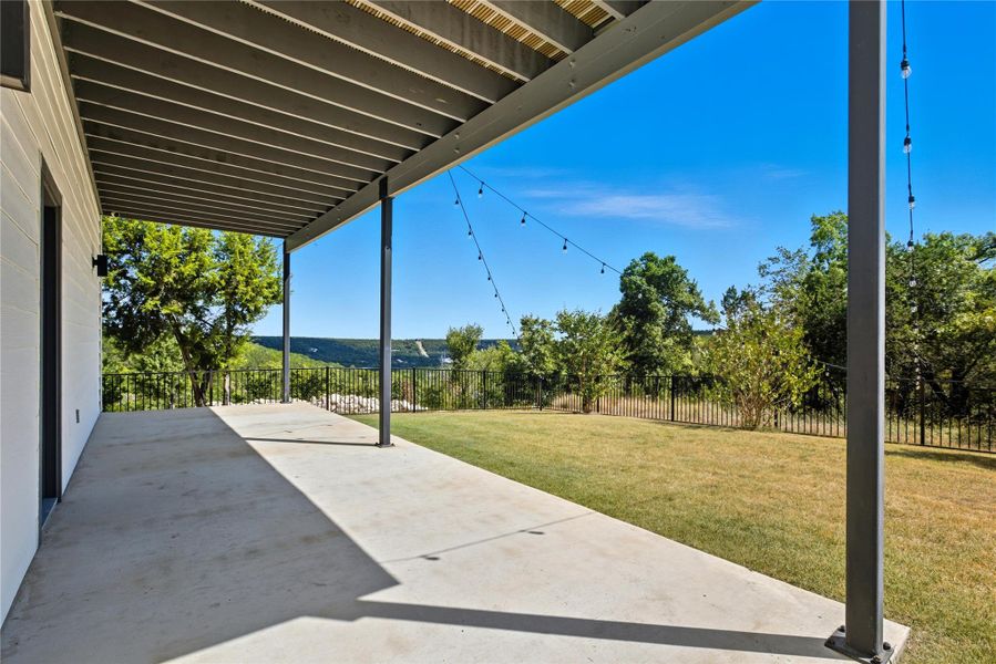 Fenced backyard with a patio area