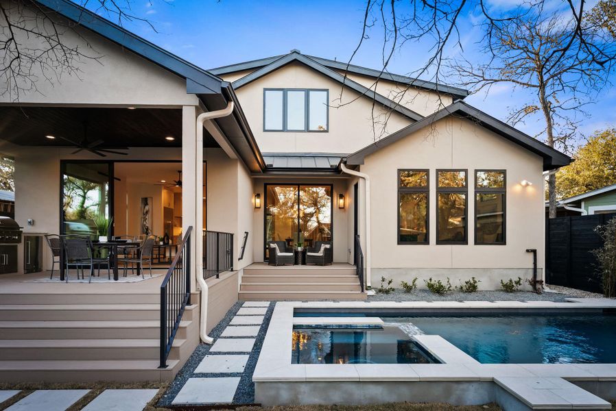 Back of property with a patio, a standing seam roof, outdoor dining area, ceiling fan, and stucco siding