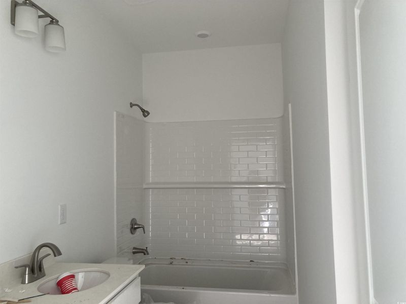 Full bath with vanity and bathtub / shower combination