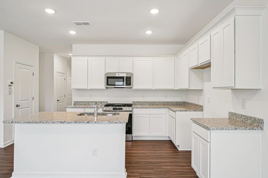 Kitchen - Chic white finishes and smooth surfaces shine.