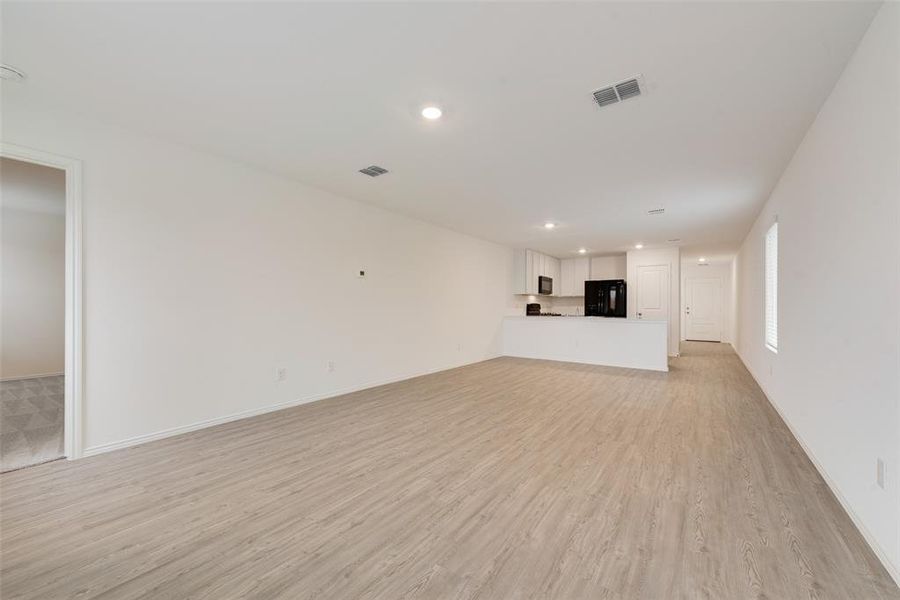 Unfurnished living room featuring light wood-type flooring