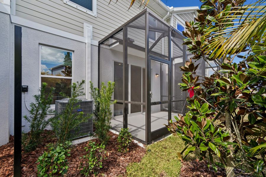 Exterior details and patio area of a home in North River Ranch – Townhomes, Parrish (Image 4).