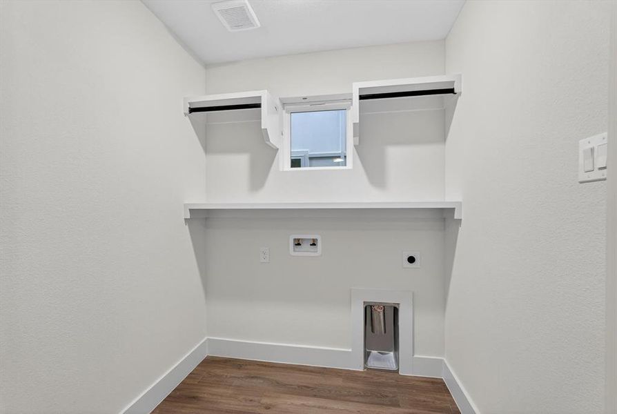 Contemporary living area featuring a built-in media wall with integrated shelving and accent lighting