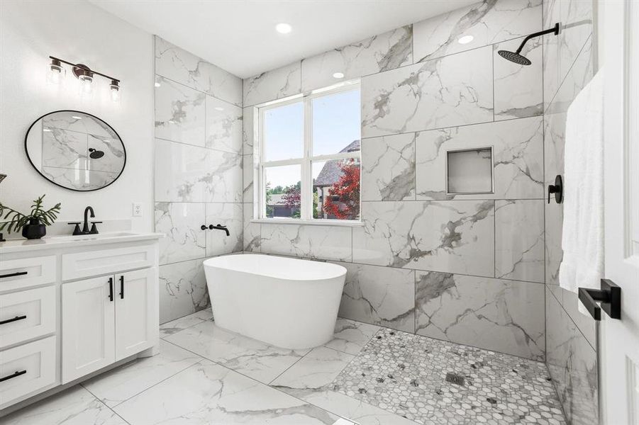 Contemporary bathroom featuring a freestanding soaking tub, a walk-in shower with a mosaic tile floor, and a double-hung window Contemporary bathroom featuring a freestanding soaking tub, a walk-in shower with a mosaic tile floor, and a double-hung window