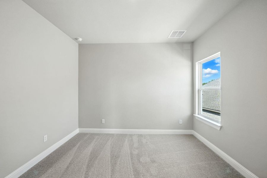 Carpeted spare room featuring baseboards Carpeted spare room featuring baseboards