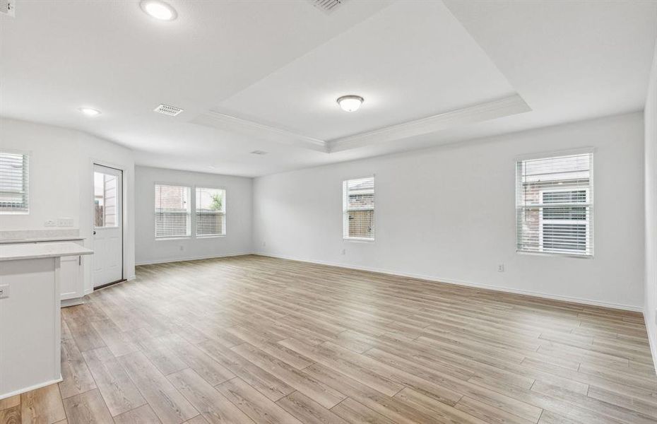 Expansive gathering room bathed in natural sunlight *Real home pictured