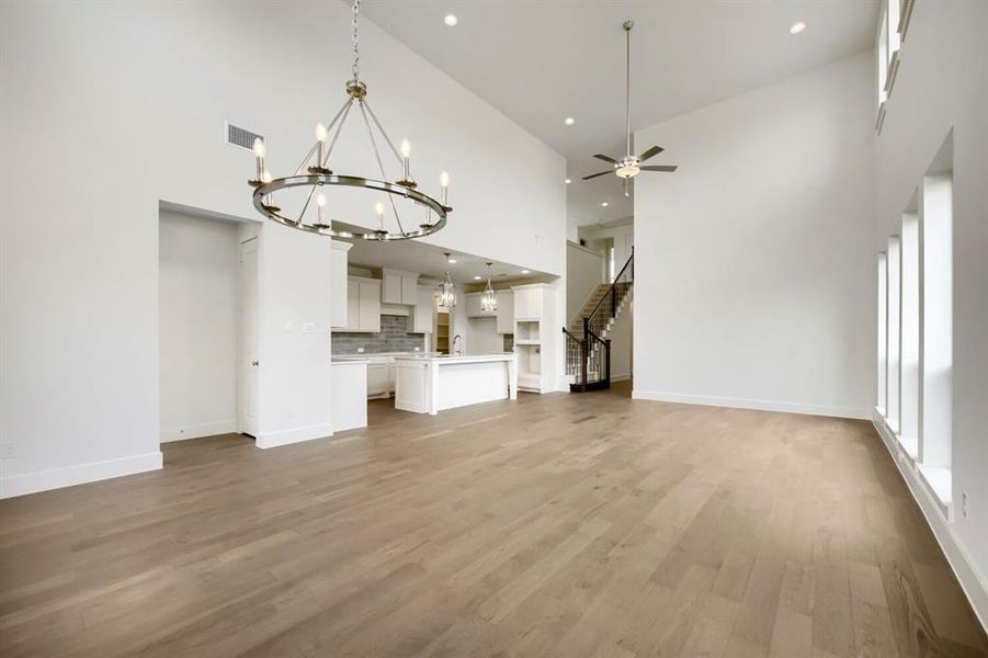 Soaring ceilings featuring a contemporary chandelier and recessed lighting Soaring ceilings featuring a contemporary chandelier and recessed lighting