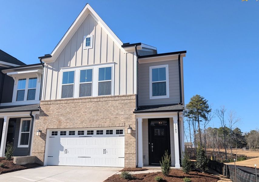 Front exterior of a new home in Ovation at Sweetbrier, Durham, NC, highlighting curb appeal (Image 1).