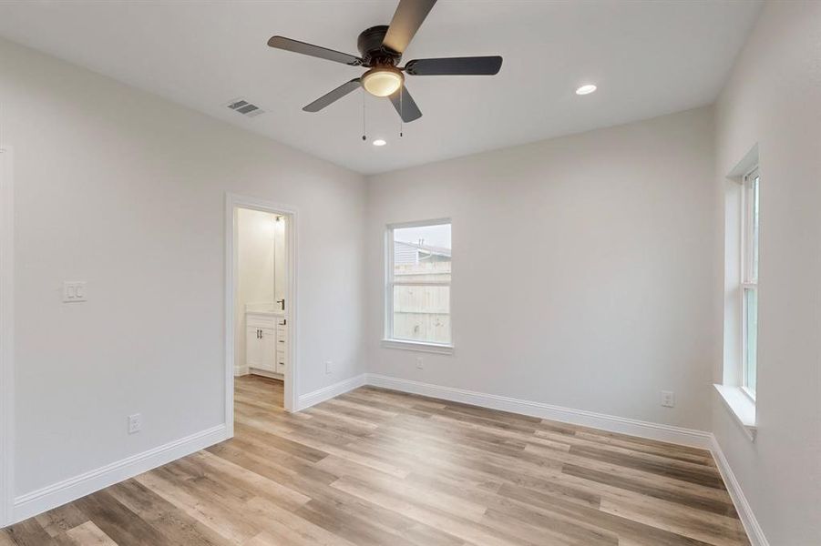 Unfurnished room featuring ceiling fan and light wood-type flooring