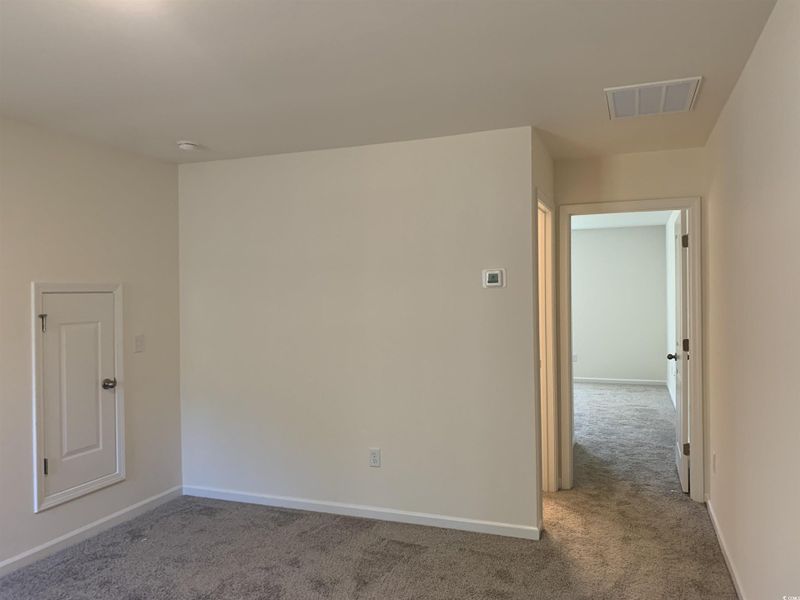 Carpeted empty room with baseboards