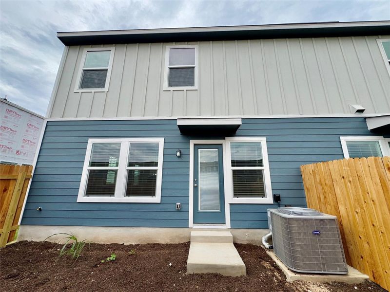 Rear view of house featuring board and batten siding