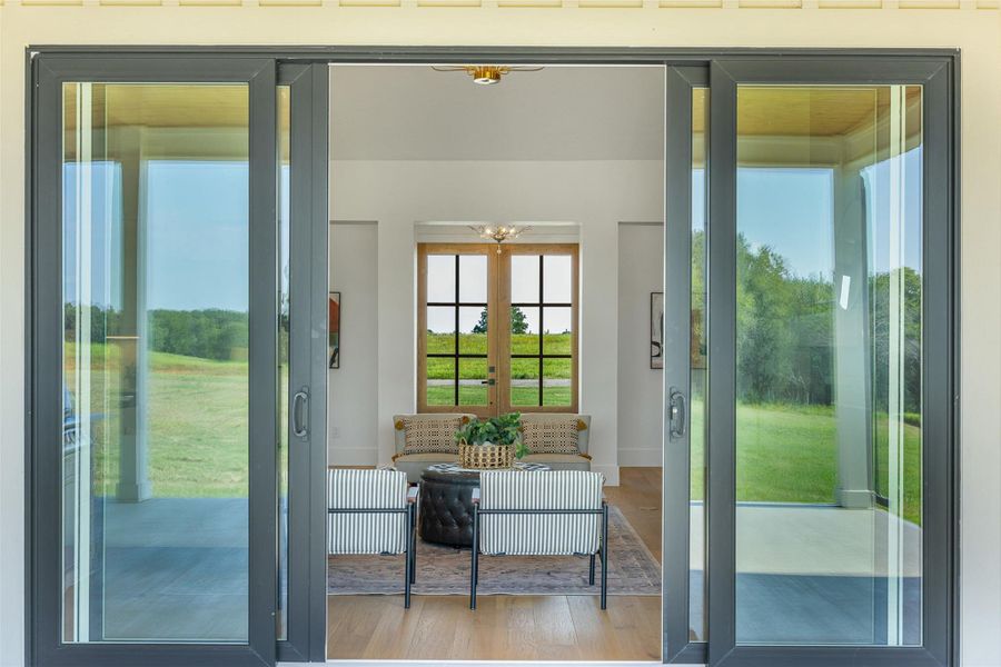 Doorway to outside featuring double sliding glass doors.