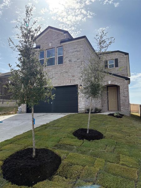 Front exterior of a new home in Creekside at Estancia, Austin, TX, highlighting curb appeal (Image 19). Front exterior of a new home in Creekside at Estancia, Austin, TX, highlighting curb appeal (Image 19).