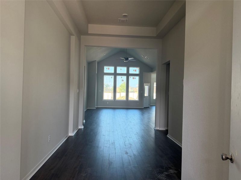 Dark wood flooring guides the eye toward a soaring vaulted ceiling in the main living space.