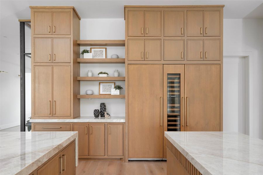 The appliances include Sub-Zero refrigerator, freezer, and wine tower, Wolf Range and microwave, and cove dishwasher.