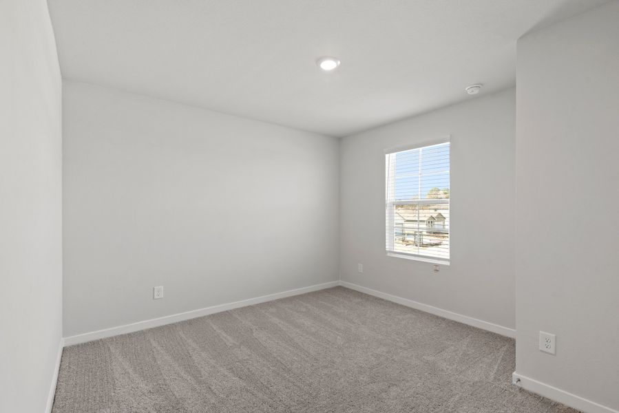 A room with a window and carpet. A room with a window and carpet.