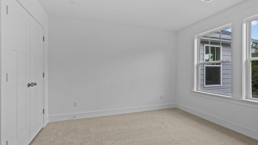 Refined bedroom design with large windows for daylight-filled mornings and peaceful views