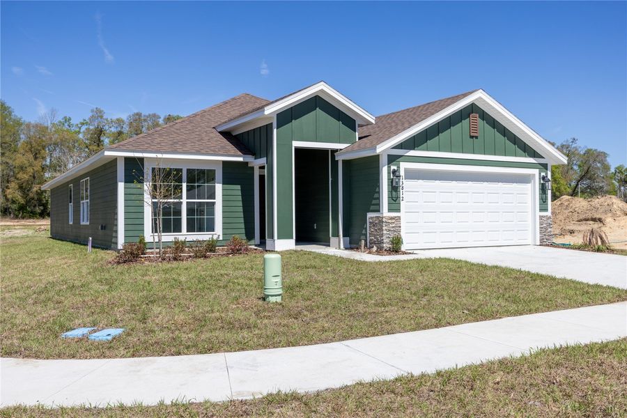 Front exterior of a new home in Kirkland Farms, Alachua, FL, highlighting curb appeal (Image 16).