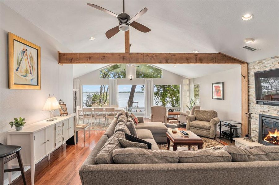 Vaulted ceiling with exposed wood beam, recessed lighting, and ceiling fan