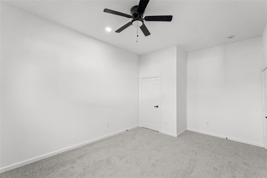 Carpeted spare room with recessed lighting and a ceiling fan