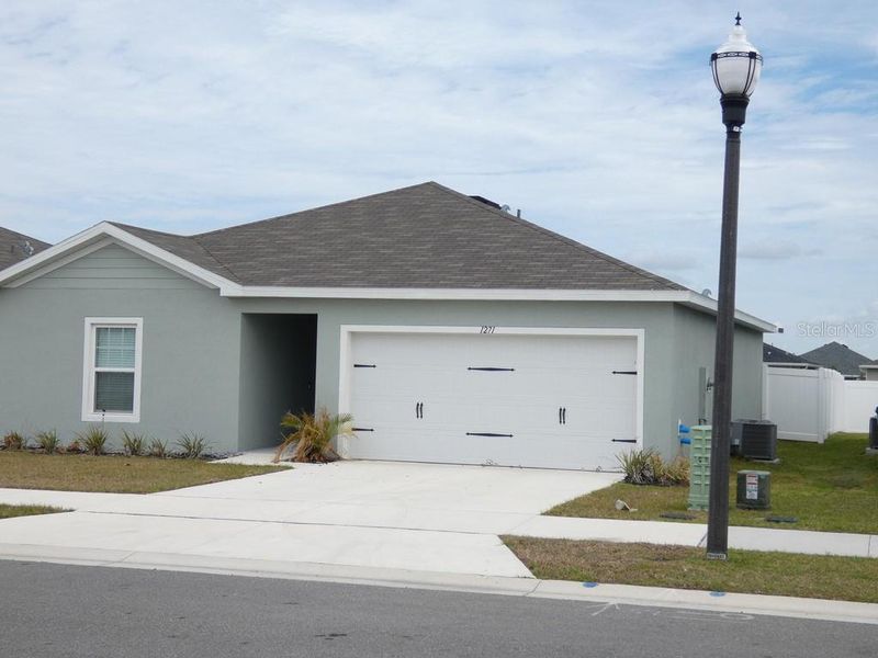 Front exterior of a new home in , Haines City, FL, highlighting curb appeal (Image 24). Front exterior of a new home in , Haines City, FL, highlighting curb appeal (Image 24).
