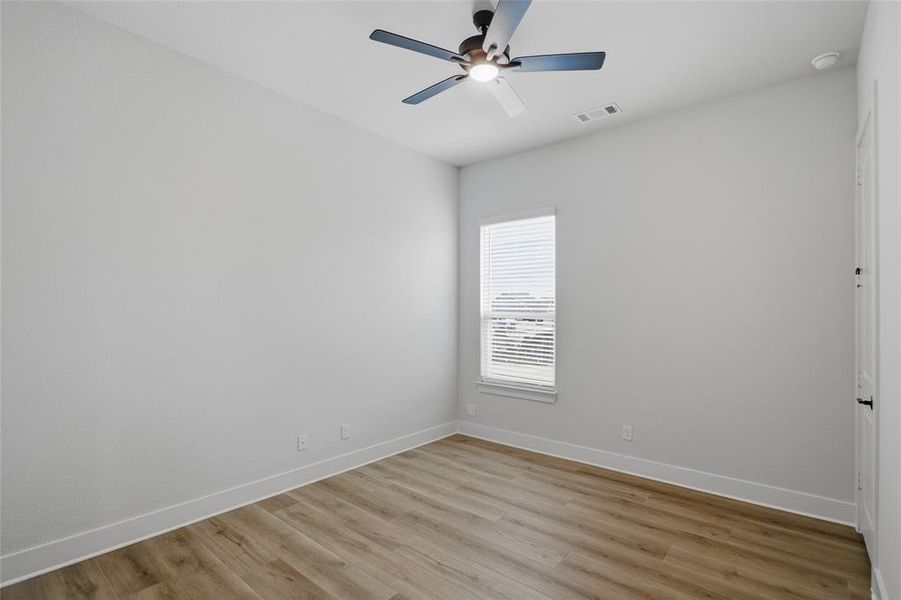 Spare room featuring light wood-style flooring and ceiling fan