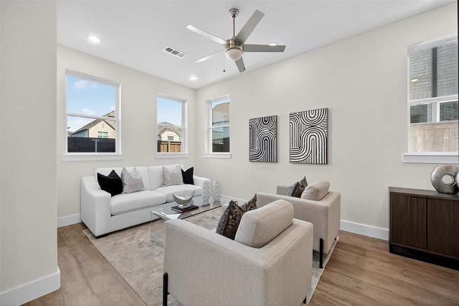 Living room with wood finished floors, recessed lighting, and ceiling fan Living room with wood finished floors, recessed lighting, and ceiling fan