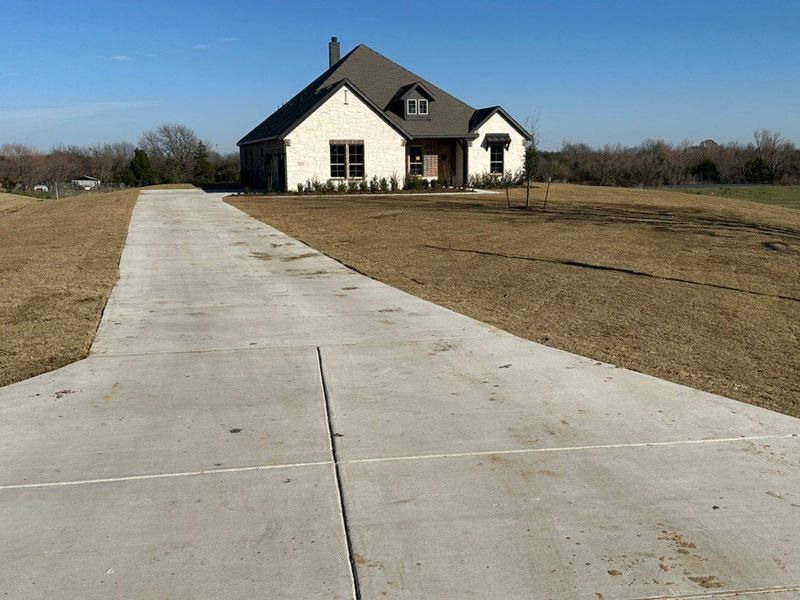 Front exterior of a new home in Fannin Ranch, Leonard, TX, highlighting curb appeal (Image 7).