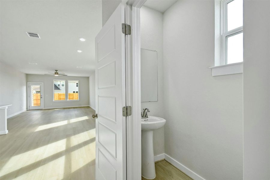 Bathroom with ceiling fan, sink, and hardwood / wood-style flooring