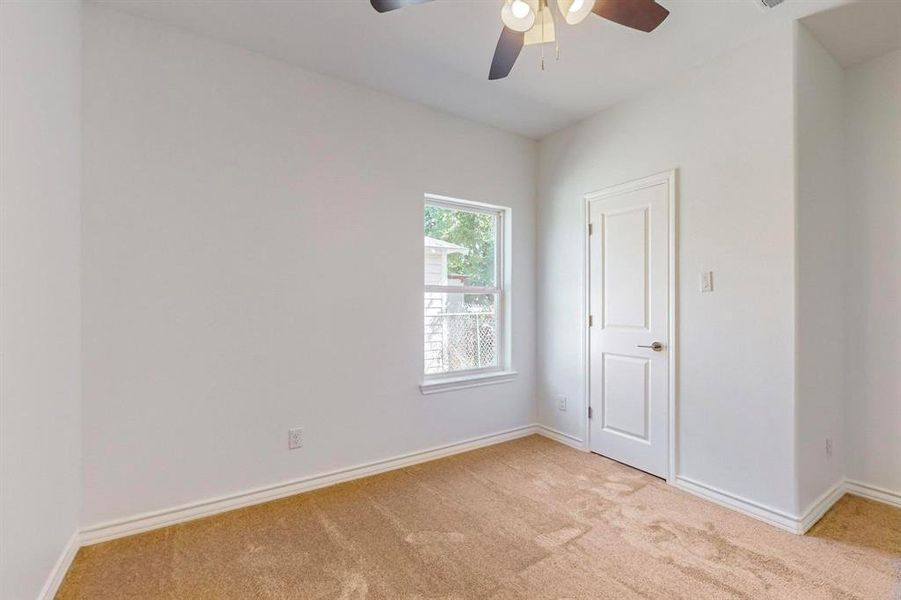 Unfurnished bedroom #2 with ceiling fan and light carpet