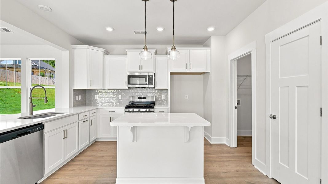 Elegant and compact island anchors this tasteful kitchen with high standards and timeless appeal