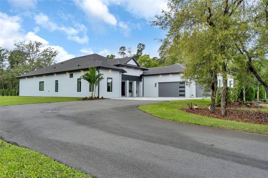 Front exterior of a new home in , Kissimmee, FL, highlighting curb appeal (Image 25). Front exterior of a new home in , Kissimmee, FL, highlighting curb appeal (Image 25).