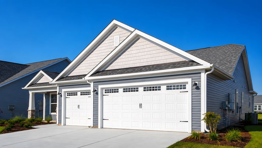 Front exterior of a new home in Bridgewater - Shorehaven Village, Little River, SC, highlighting curb appeal (Image 1). Front exterior of a new home in Bridgewater - Shorehaven Village, Little River, SC, highlighting curb appeal (Image 1).