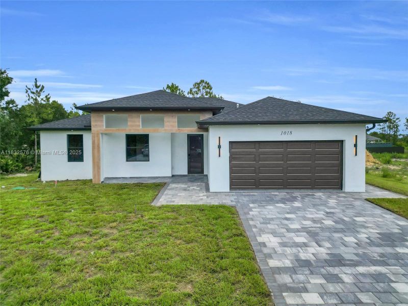 Front exterior of a new home in , Lehigh Acres, FL, highlighting curb appeal (Image 38).