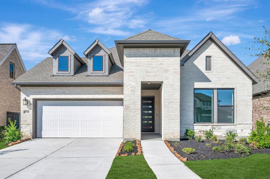 Front exterior of a new home in Riceland - Enclave Collection, Mont Belvieu, TX, highlighting curb appeal (Image 2). Front exterior of a new home in Riceland - Enclave Collection, Mont Belvieu, TX, highlighting curb appeal (Image 2).