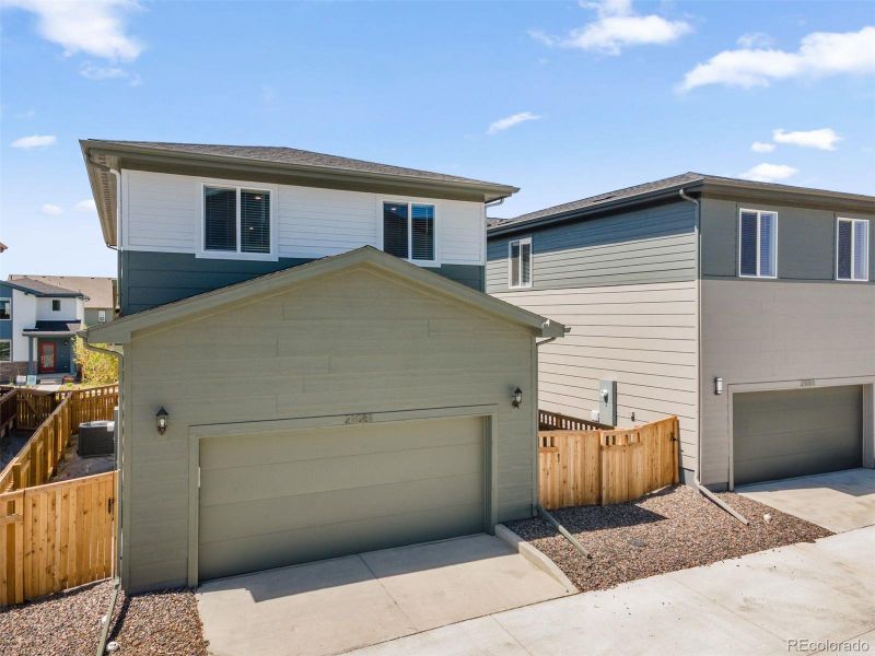 Front exterior of a new home in Woodrose at Painted Prairie, Aurora, CO, highlighting curb appeal (Image 2). Front exterior of a new home in Woodrose at Painted Prairie, Aurora, CO, highlighting curb appeal (Image 2).