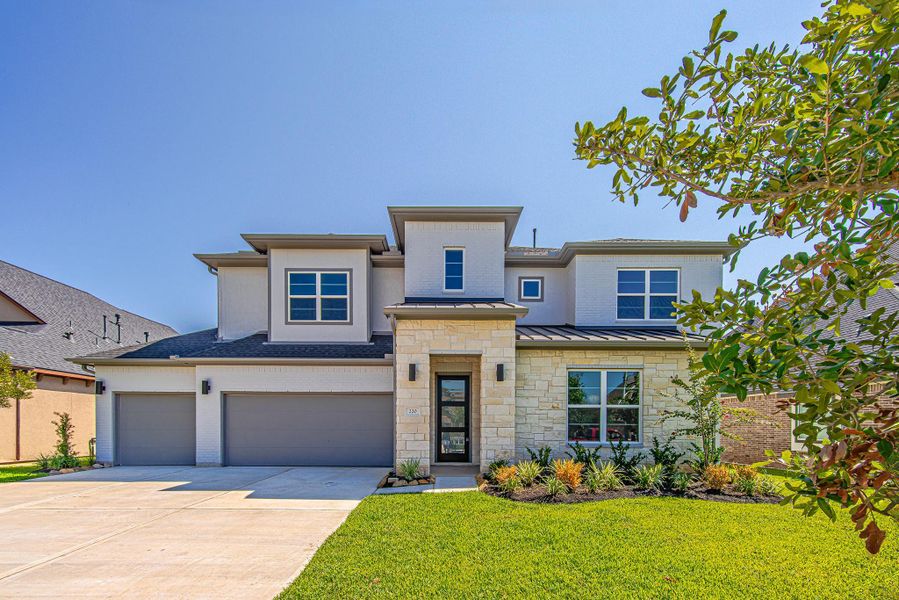 Front exterior showcasing the contemporary design, brick accents, and spacious driveway
