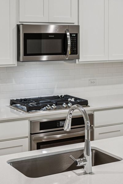 Kitchen in the Oscar home plan by Trophy Signature Homes – REPRESENTATIVE PHOTO Kitchen in the Oscar home plan by Trophy Signature Homes – REPRESENTATIVE PHOTO