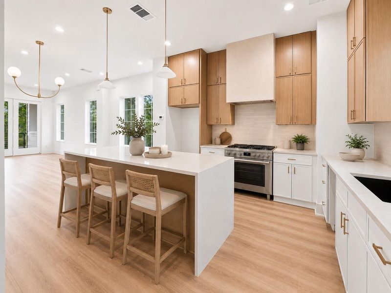 Chef's kitchen includes stainless steel appliances and ample cabinetry for storage.